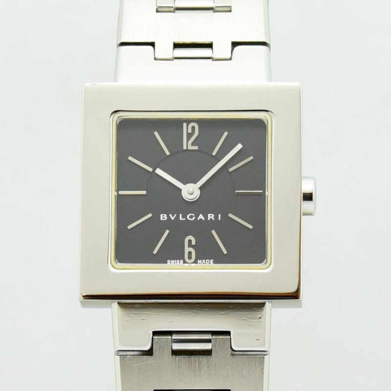 VINTAGE WATCHES FASHION ブルガリのスクエアフェイスレディース腕時計。シルバーカラーのステンレススチール製ケースとブレスレット、ダークグレーの文字盤。12時と6時のアラビア数字がアクセント。