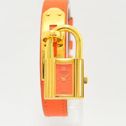 VINTAGE WATCHES FASHIONのエルメス ケリーウォッチ。鮮やかなオレンジのレザーベルトとゴールドの南京錠型ケースが特徴的なレディース腕時計。