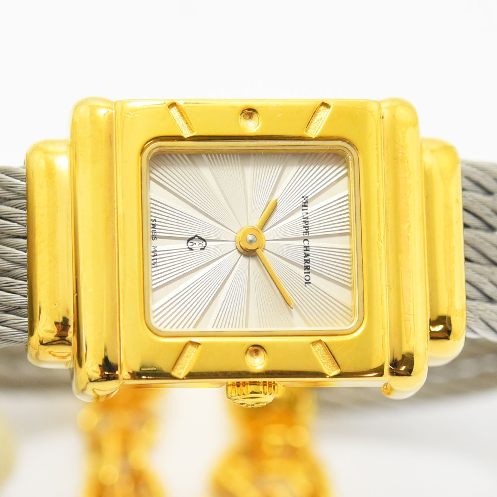 VINTAGE WATCHES FASHIONのフィリップ・シャリオール製レディース腕時計。ゴールドのスクエアケースとシルバーのワイヤーケーブルブレスレットが特徴的で、放射状の文字盤が上品な輝きを放ちます。