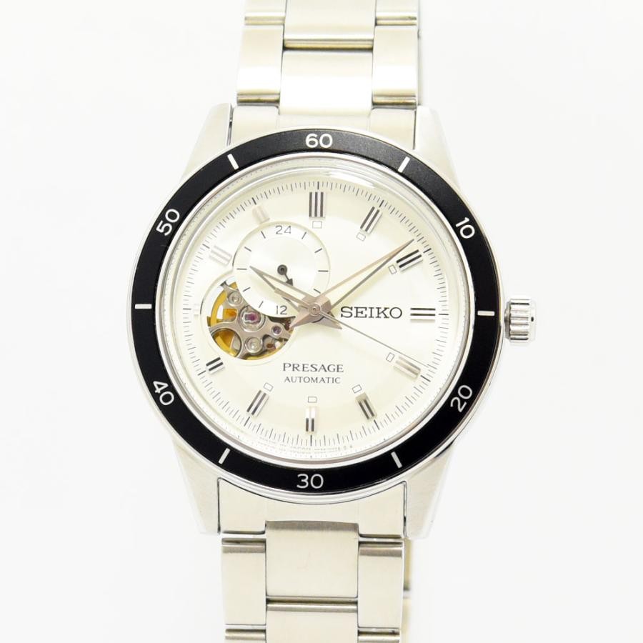 VINTAGE WATCHES FASHION プレザージュ オートマチック ウォッチ。オフホワイトの文字盤、ローマ数字インデックス、オープンハートデザイン、ブラックセラミックベゼル、ステンレススチールブレスレット。
