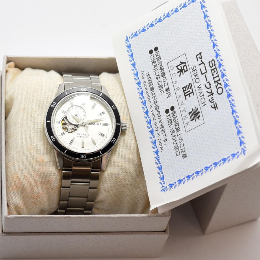VINTAGE WATCHES FASHION プレザージュ オートマチック ウォッチ。オフホワイトの文字盤、ローマ数字インデックス、オープンハートデザイン、ブラックセラミックベゼル、ステンレススチールブレスレット。